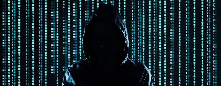 Hooded Man on a Background Filled with Codes 