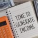 Time To Generate Income wording with a calculator. Financial, finance, business concept