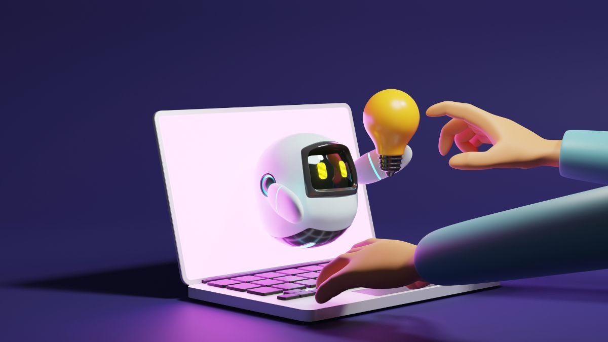 User hand touching cute robot light bulb through laptop on purple